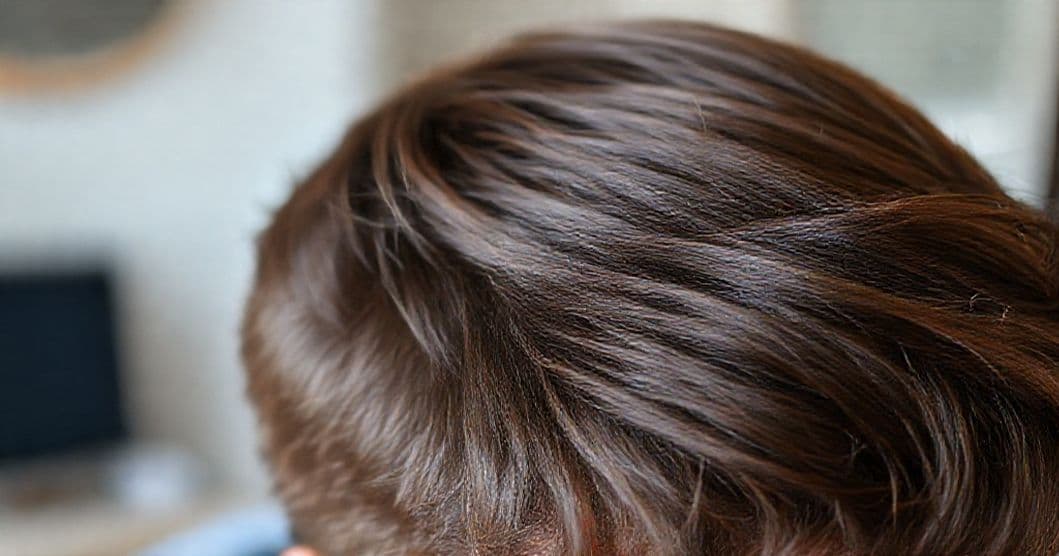 Close-up of man's hair with visible regrowth along a natural hairline
